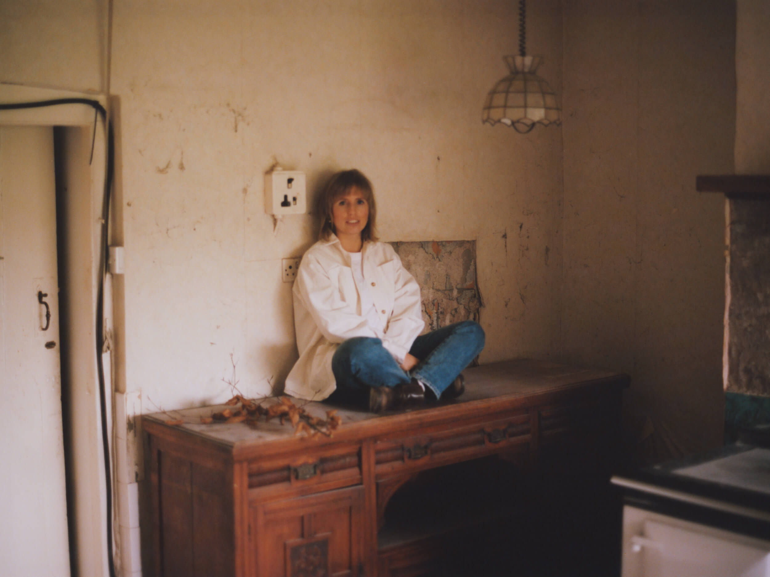 Lucy Augé, British-French artist based in Bath, Somerset. Portrait photograph in the studio, 2022. Photo by Roo Lewis